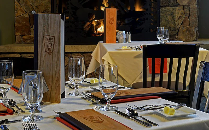 Fireside fine dining setup with charcuterie board and wine at a Steamboat Luxury Rentals property. Fireside fine dining setup with charcuterie board and wine at a Steamboat Luxury Rentals property.