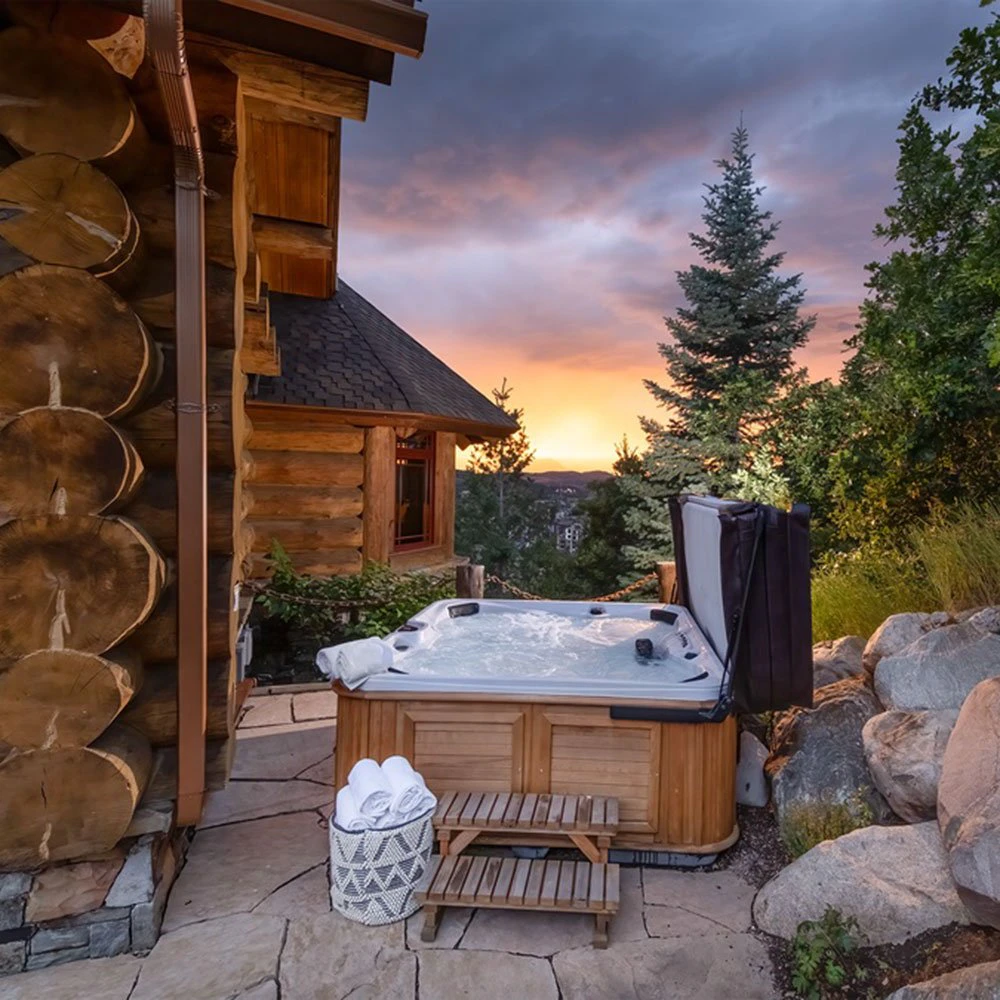 Private outdoor hot tub at See Me Lodge, a premier cabin-style retreat with wraparound stone patio and mountain views—part of Steamboat Luxury Rentals. Private outdoor hot tub at See Me Lodge, a premier cabin-style retreat with wraparound stone patio and mountain views—part of Steamboat Luxury Rentals.