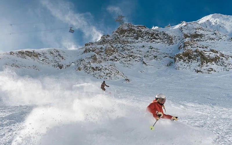 Skier on fresh powder at Big Sky Resort, a top winter attraction near Big Sky luxury rentals. Skier on fresh powder at Big Sky Resort, a top winter attraction near Big Sky luxury rentals.