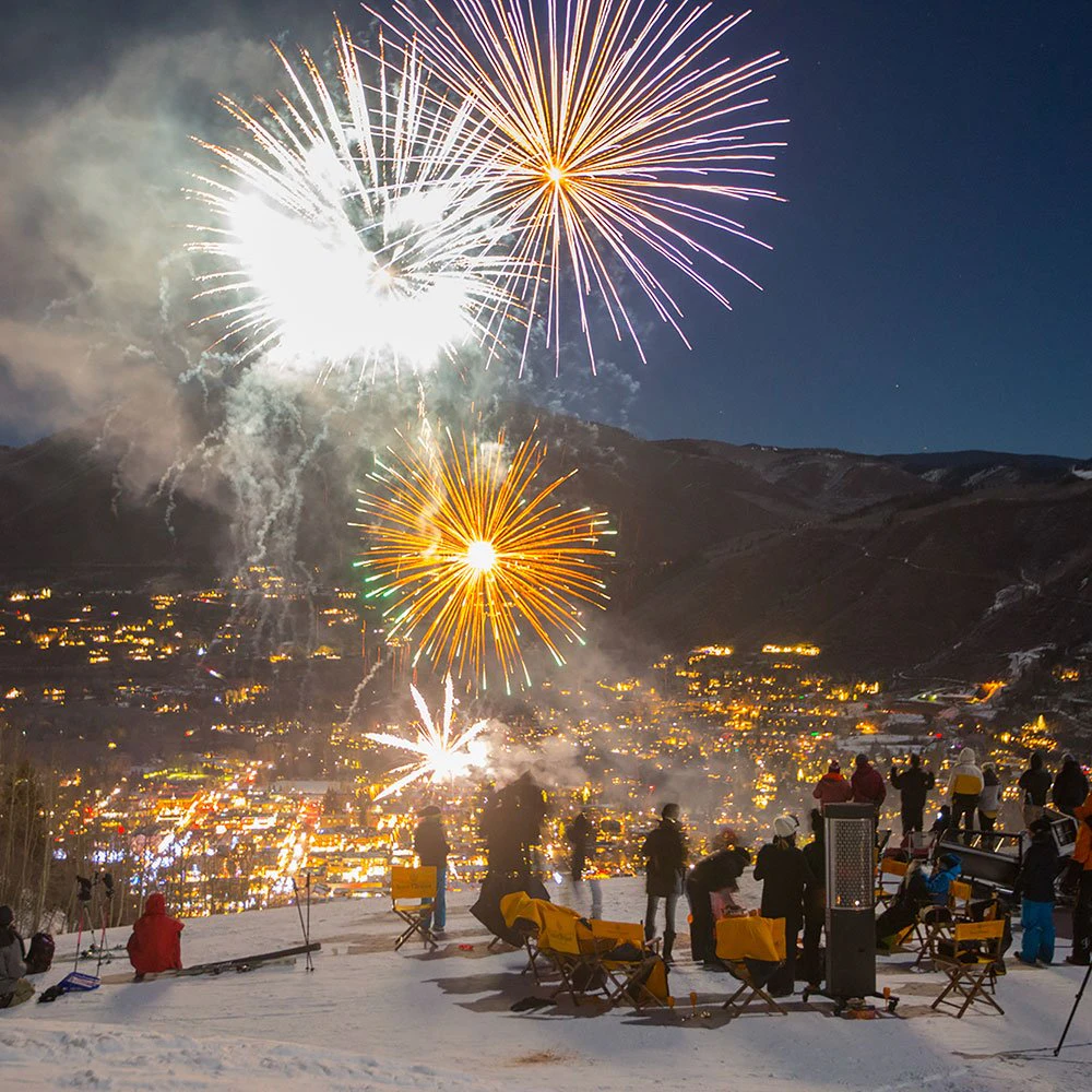 Fireworks over snowy Aspen at night during winter festivities, showcasing the vibrant atmosphere near Aspen vacation rentals. Fireworks over snowy Aspen at night during winter festivities, showcasing the vibrant atmosphere near Aspen vacation rentals.