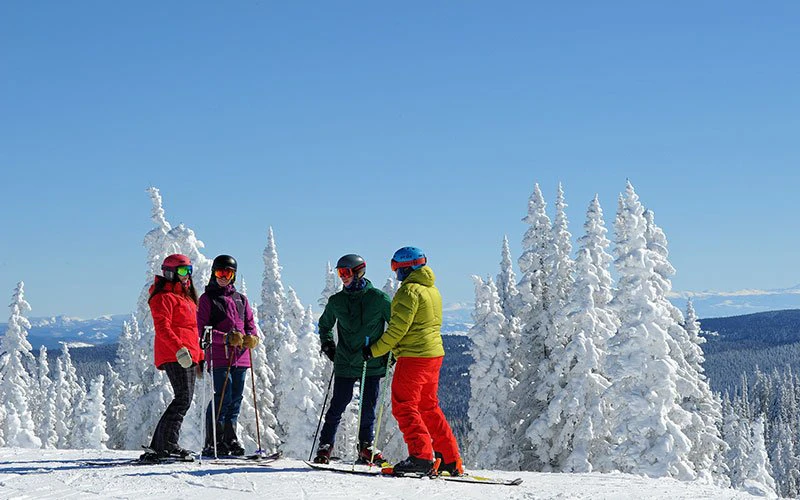 Group of skiers on a snowy ridge at Steamboat Resort—expertly guided winter experiences arranged through Steamboat Luxury Rentals. Group of skiers on a snowy ridge at Steamboat Resort—expertly guided winter experiences arranged through Steamboat Luxury Rentals.