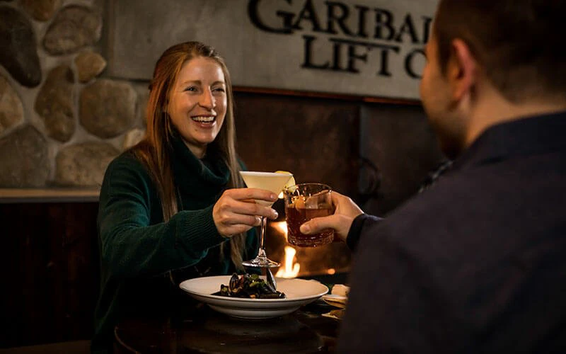 Guests enjoying fine dining at Garibaldi Lift Co., a culinary experience arranged through Whistler Luxury Rentals.