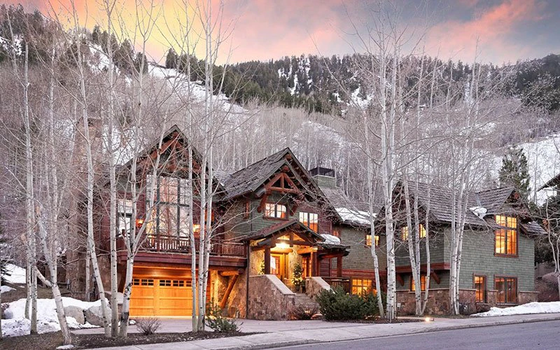 Rustic mountain exterior of 938 Mill Street, a premium Aspen ski-in/ski-out estate perfect for large group getaways.