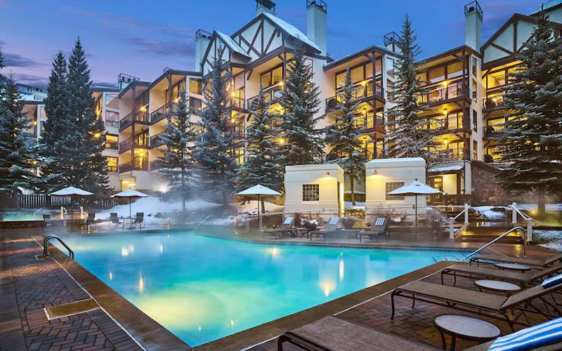 Montaneros 402 Vail ski-in/ski-out condo complex with heated outdoor pool and alpine backdrop.
