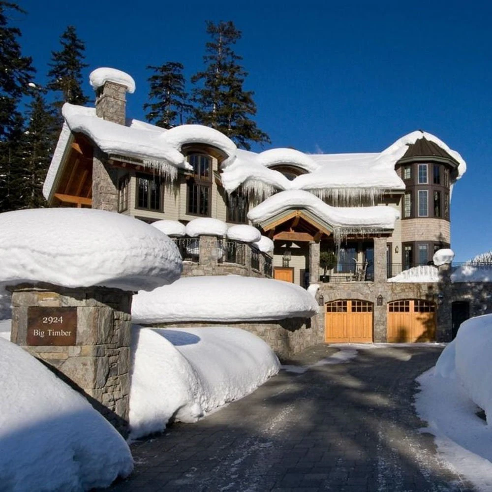 whistler-ski-in-ski-out-intro-image-Chateau-Mondeau Chateau Mondeau Whistler ski-in/ski-out mountain home with snow-covered roof and alpine forest backdrop.