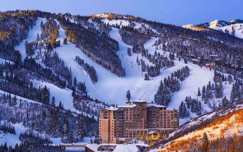 Aerial winter view of St. Regis Deer Valley hotel nestled on the ski slopes, showcasing premier Deer Valley ski-in/ski-out access.