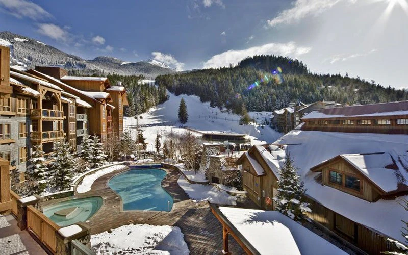 Legends Whistler ski-in/ski-out condos at Creekside with pool and mountain views.