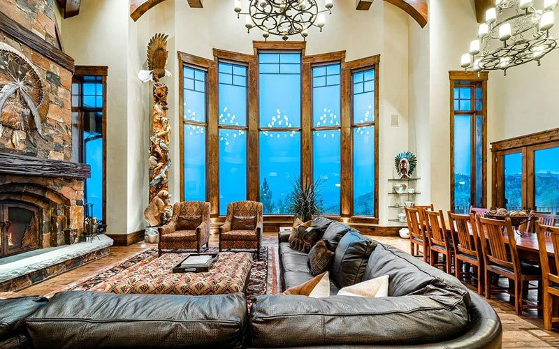 Interior of Black Spruce Lodge with high ceilings and mountain views, showcasing a Deer Valley ski-in/ski-out private residence.