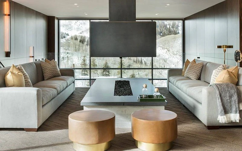 Modern living area at One Empire Pass with expansive snowy views, showcasing upscale Deer Valley ski-in/ski-out condo living.