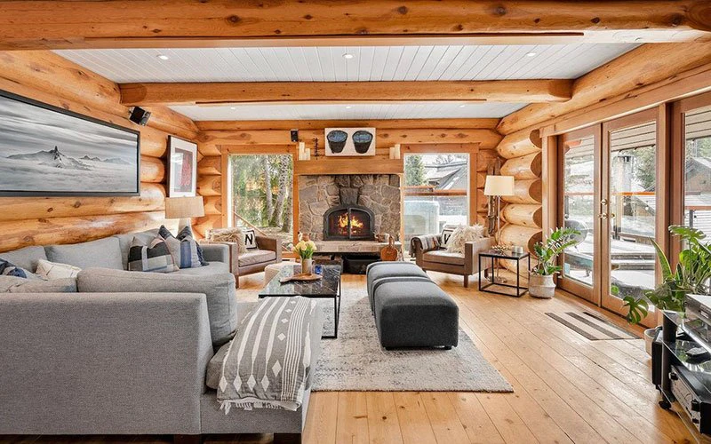 Snowridge Haven Whistler ski-in/ski-out log cabin with wood interior and stone fireplace.