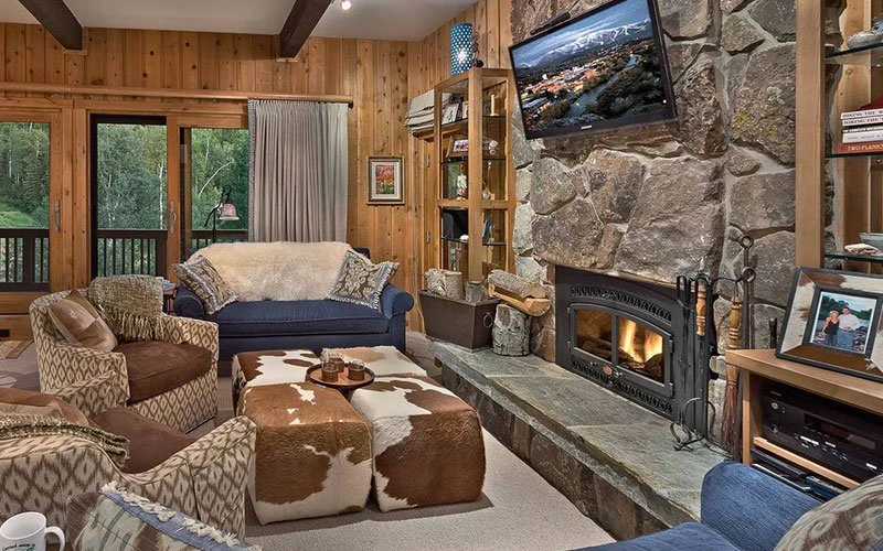 Right-O-Way Chalet Steamboat Springs Ski-in/Ski-out home with rustic living room and stone fireplace.