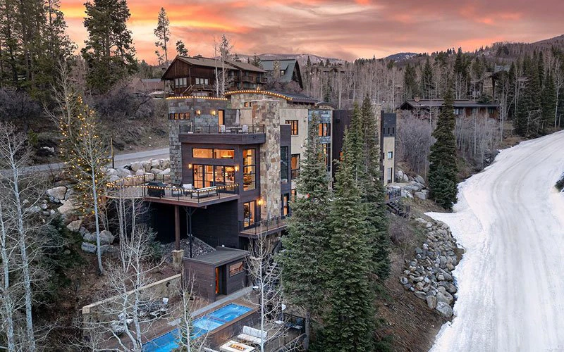Over the Edge Steamboat Springs Ski-in/Ski-out private estate with stone exterior and forest views.