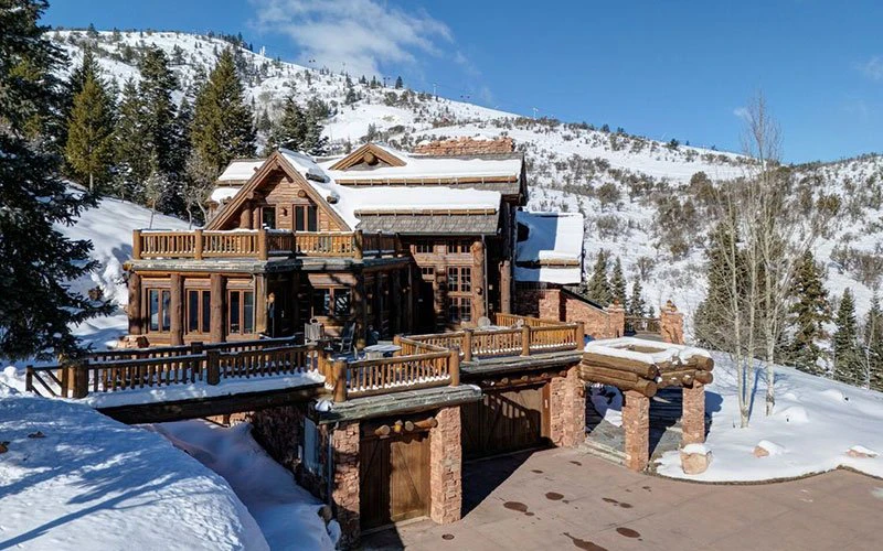 Rustic log cabin exterior of The Treehouse, a five-bedroom Park City ski-in/ski-out home in White Pine Ranches.