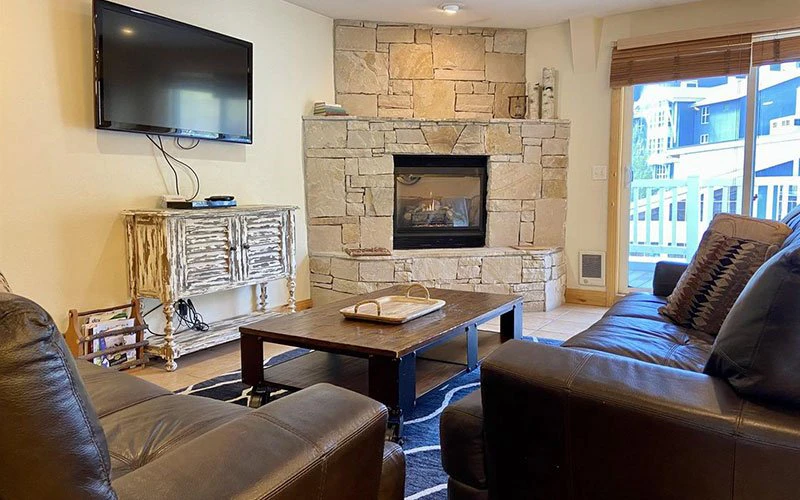Comfortable living room with fireplace at Resort Plaza, centrally located among Park City Condos at the base of the mountain.