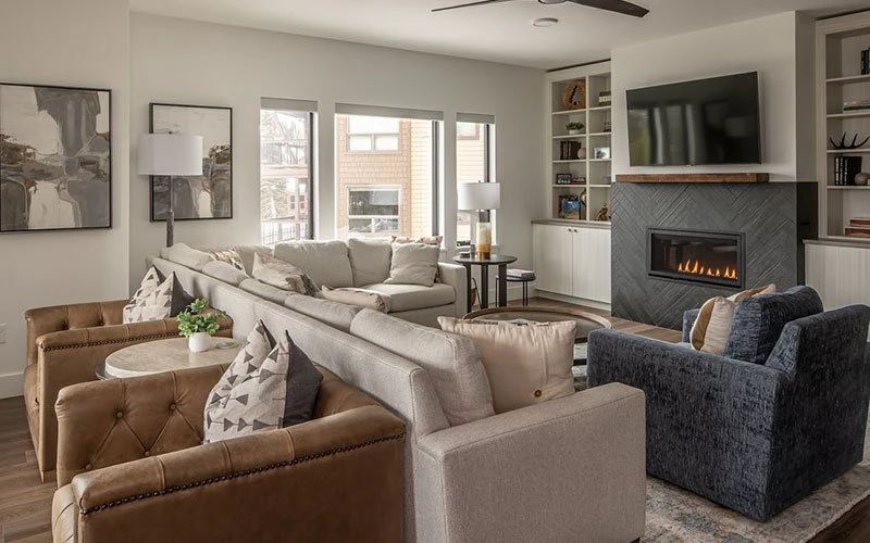 Spacious alpine living room at Beaverhead, centrally located Big Sky Condos with fireplace and modern décor.