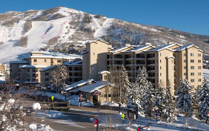 Torian Plum condominium complex with direct lift access and mountain backdrop, offering slopeside Steamboat Springs Condos
