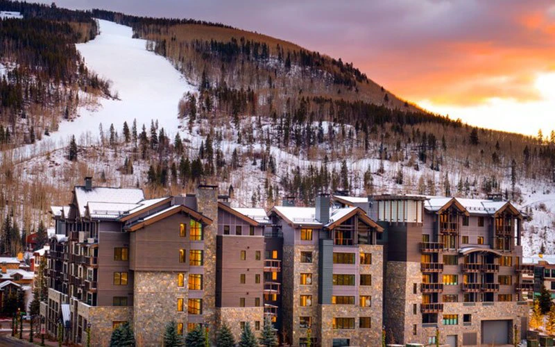 Snow-covered exterior of The Lion in Vail’s Lionshead Village, a modern alpine Vail Condo with luxurious amenities and easy lift access.
