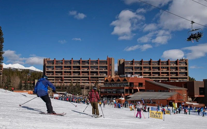Skiers enjoying the slopes outside Beaver Run Resort, a popular Breckenridge Condos destination with direct lift access and resort-style amenities