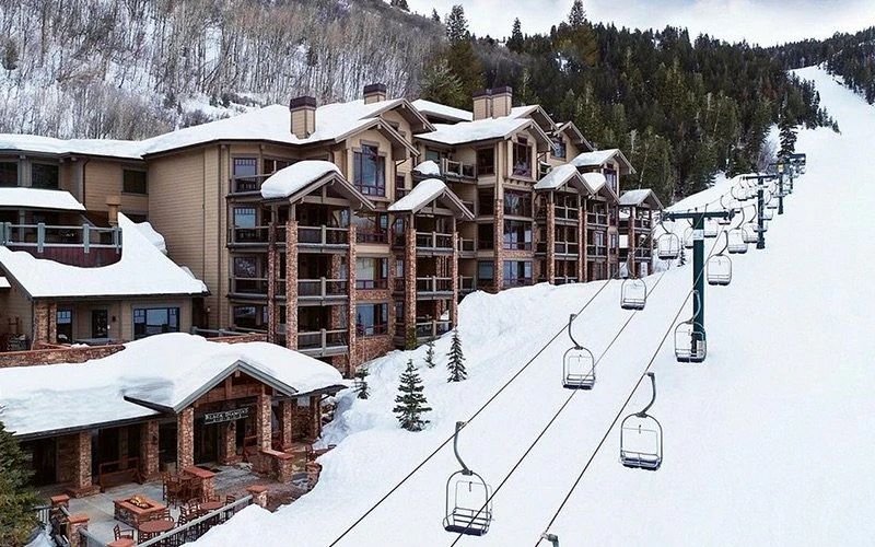 Ski-in/ski-out access shown at Black Diamond Lodge with chairlift out front, ideal for family-friendly Deer Valley Condos near the base area.