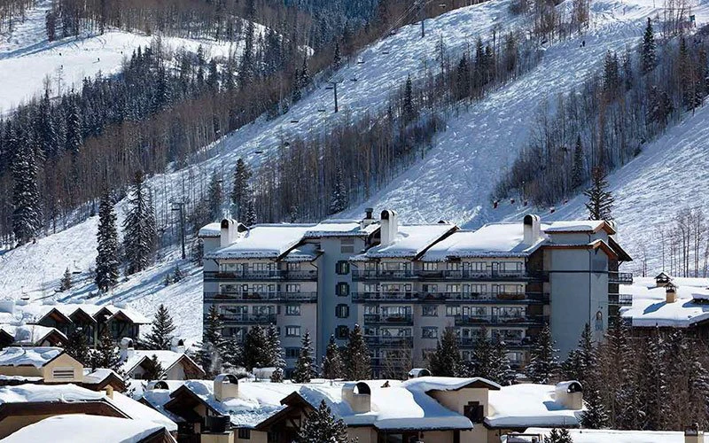 Slopeside Lodge Tower in Vail Village with snowy surroundings, an inviting Vail Condo offering ski access and resort-style relaxation.