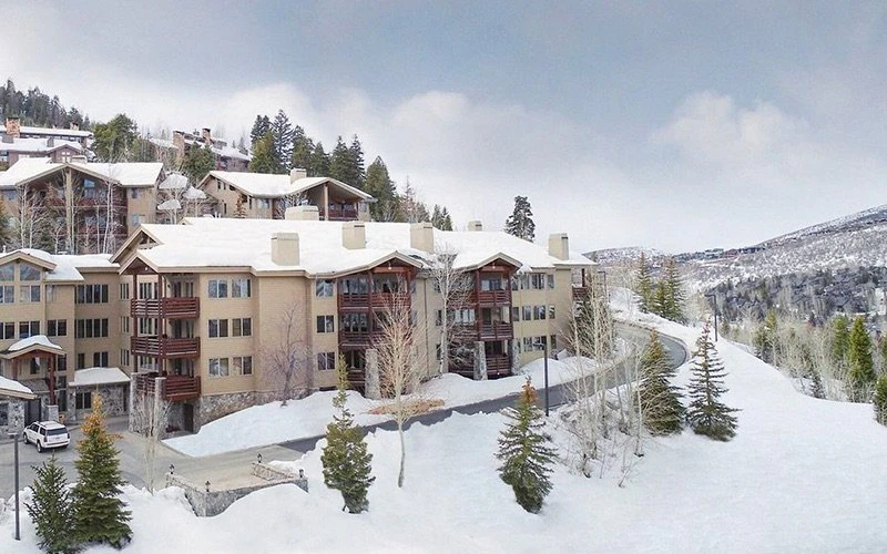 Exterior winter view of Trail’s End Lodge with private balconies and slope access, representing scenic Deer Valley Condos with hot tubs.