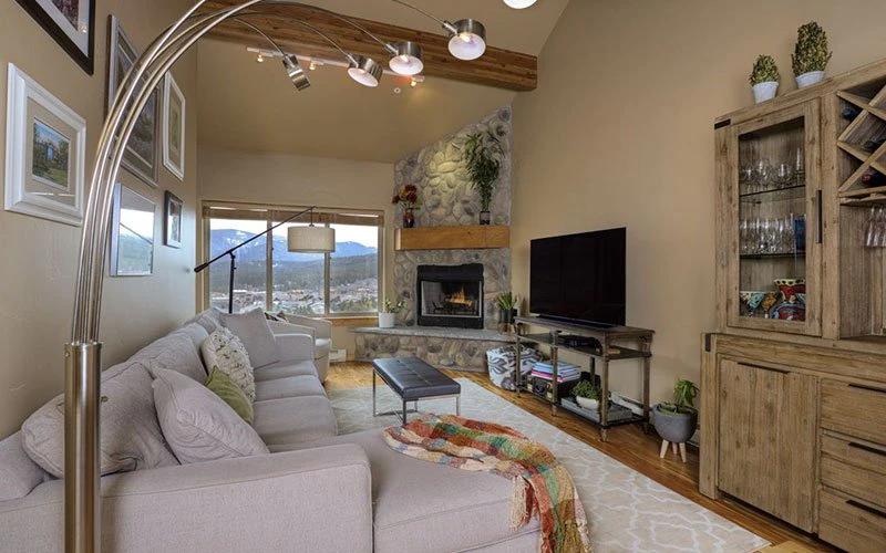 Comfortable hillside living room at Deer Run, offering peaceful scenery and residential charm among Big Sky Condos.
