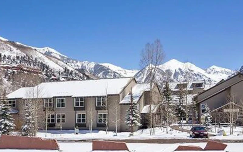 Mountainside Inn Telluride condos located near Lift #7 with snow-covered rooftops and stunning mountain scenery.