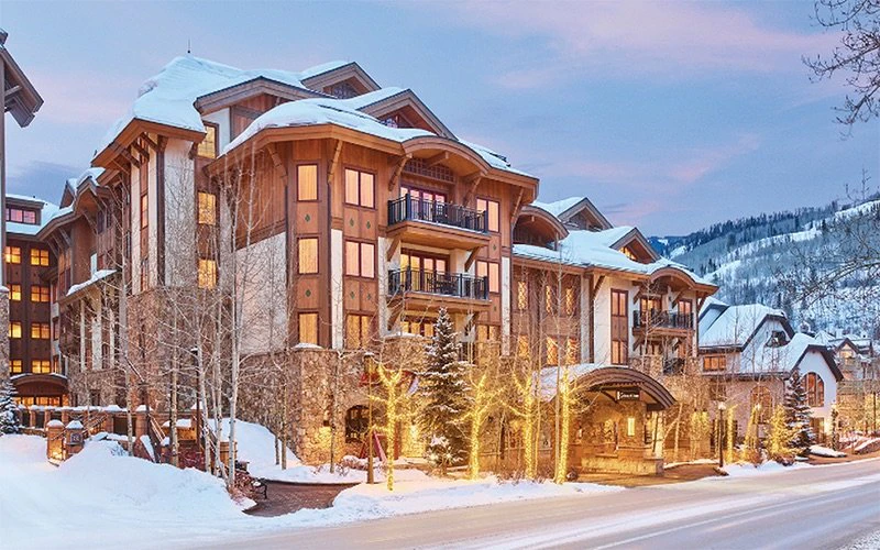 Warm alpine-style architecture at The Sebastian, luxury Vail Condos in Vail Village offering a boutique hotel experience with spa and pool.
