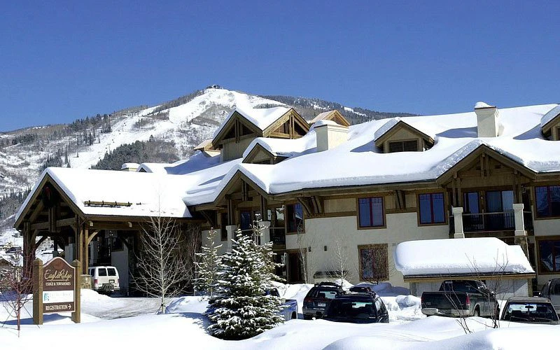 Snowy exterior of EagleRidge Lodge with mountain views, offering lodge-inspired Steamboat Springs Condos near the base