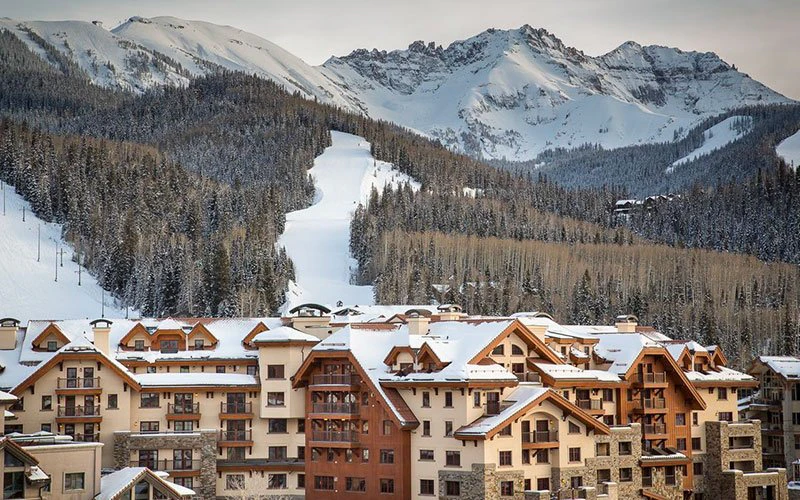 Luxury Telluride condos at The Madeline Hotel with direct slope access and panoramic views of the snow-covered San Juan Mountains.