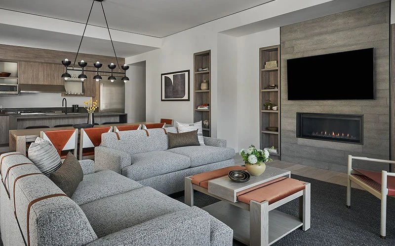 Living room with sleek fireplace and modern furnishings at Pendry Park City, a luxury Park City Condos option in Canyons Village.