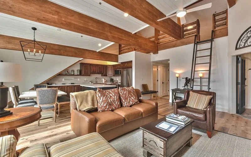 Interior of Black Bear condo with exposed wooden beams and cozy furnishings, representing classic mountain-style Deer Valley Condos.
