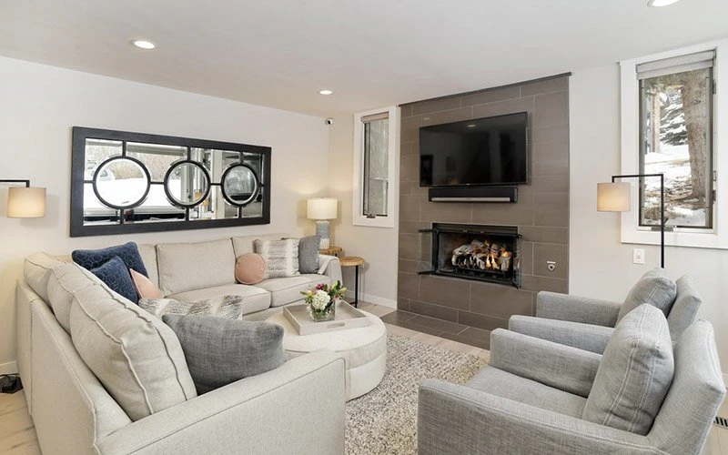Tamarack Jackson Hole Condos living room with modern mountain décor, fireplace, and cozy seating area.