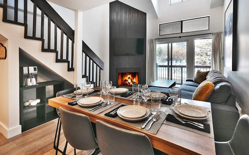 Snowcrest Park City Condos modern dining area with fireplace and mountain views near ski lifts.