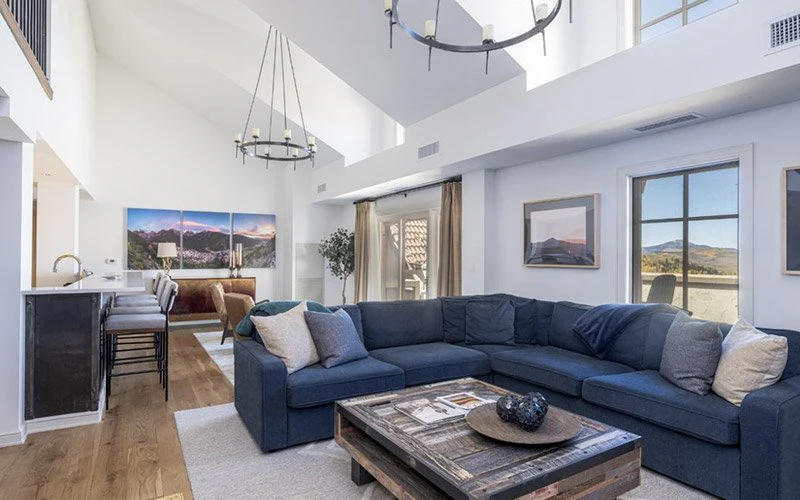 Hotel Madeline Telluride Vacation Rentals bright living room with modern décor, vaulted ceilings, and mountain views.